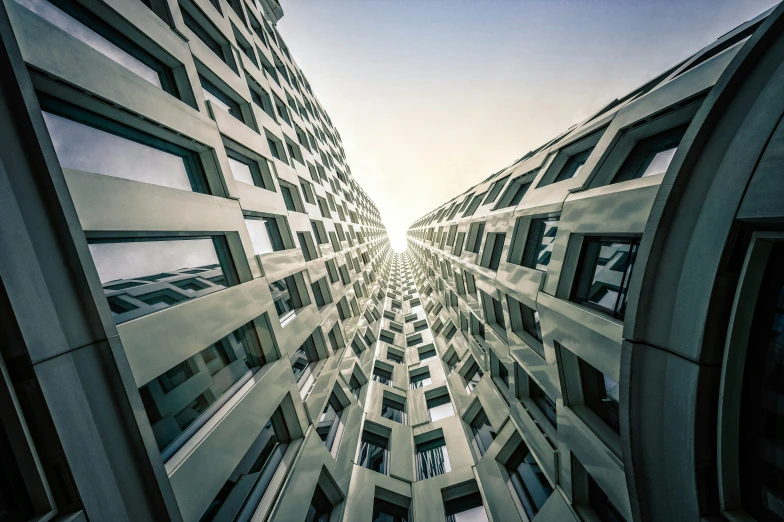 looking up at buildings in a building with a sky background