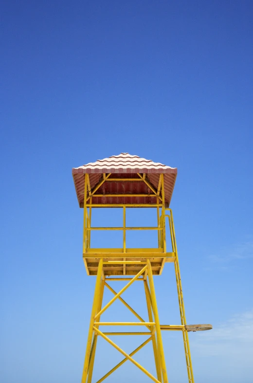 an ocean life guard tower next to the shore