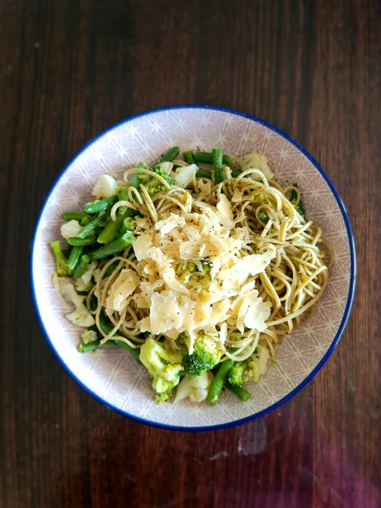 there is noodle and broccoli in the bowl