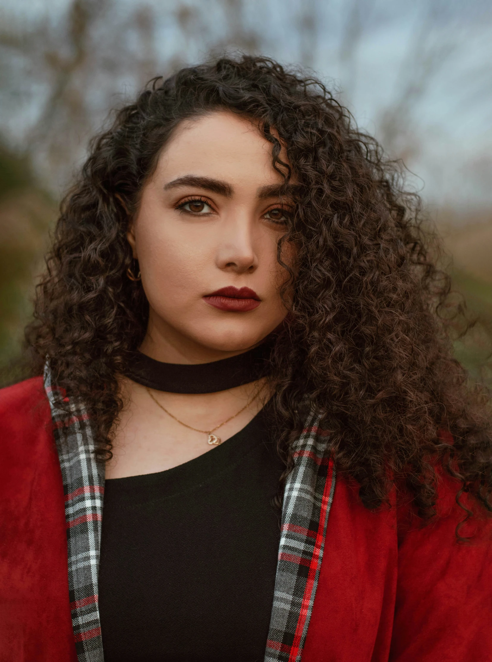 the woman is wearing a black and red coat