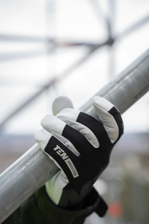 gloved gloves sit on the rail of a structure