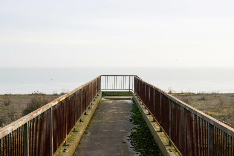 the open walkway extends to the beach to the sea