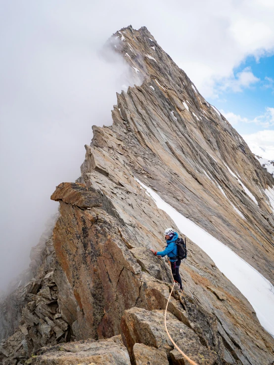 a person is climbing up a mountain side