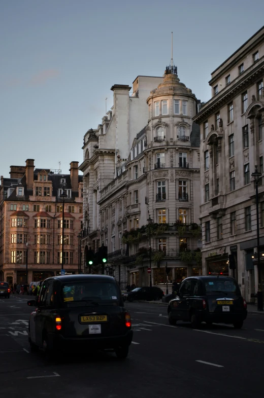 some cars on the street in an old city