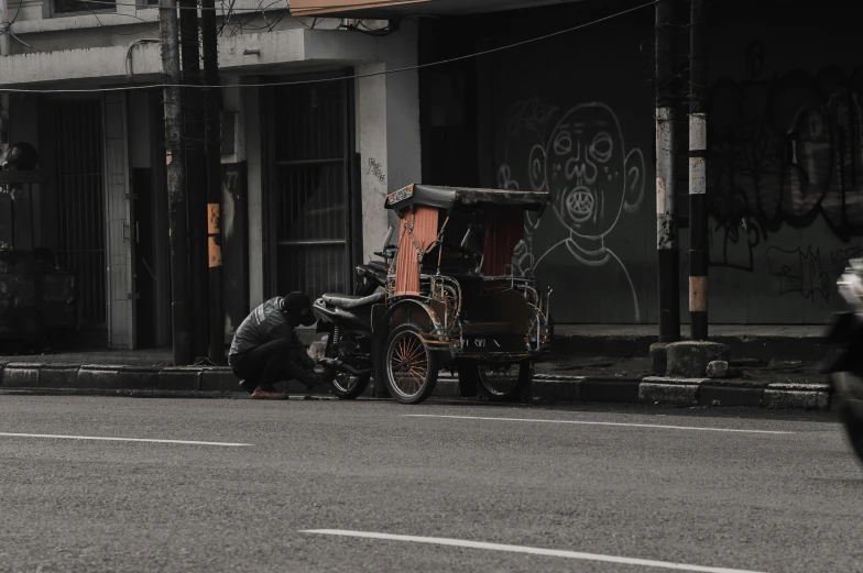 an old timey buggy sitting in the middle of a street