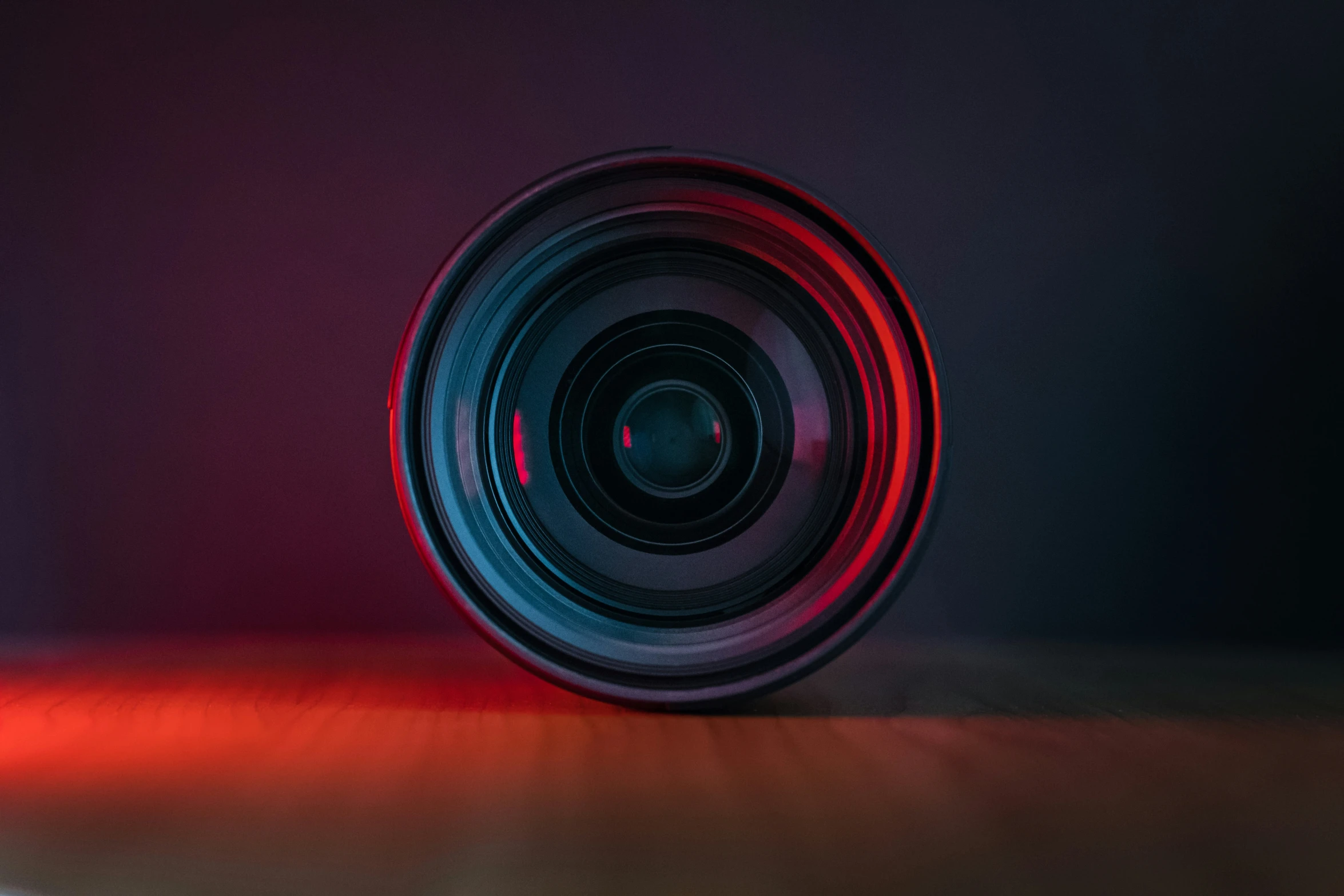 a camera lens in the darkness with red light