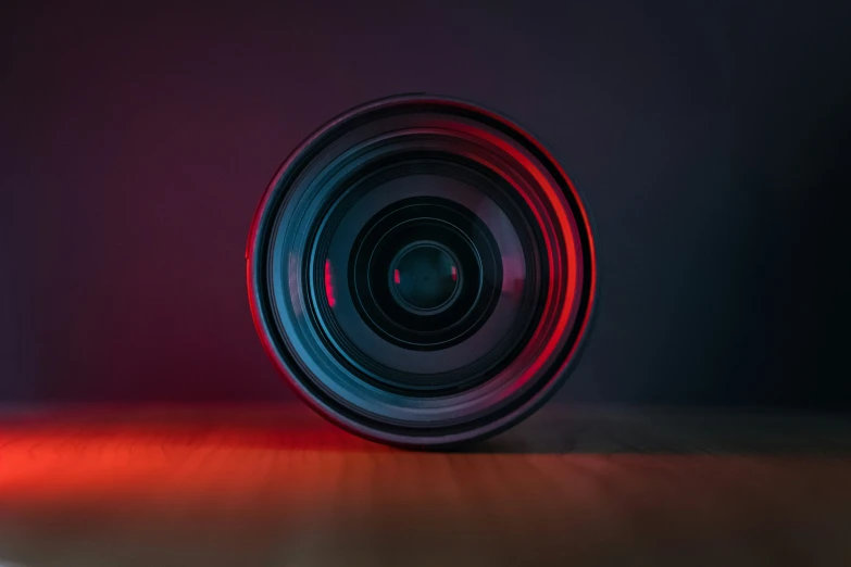 a camera lens in the darkness with red light