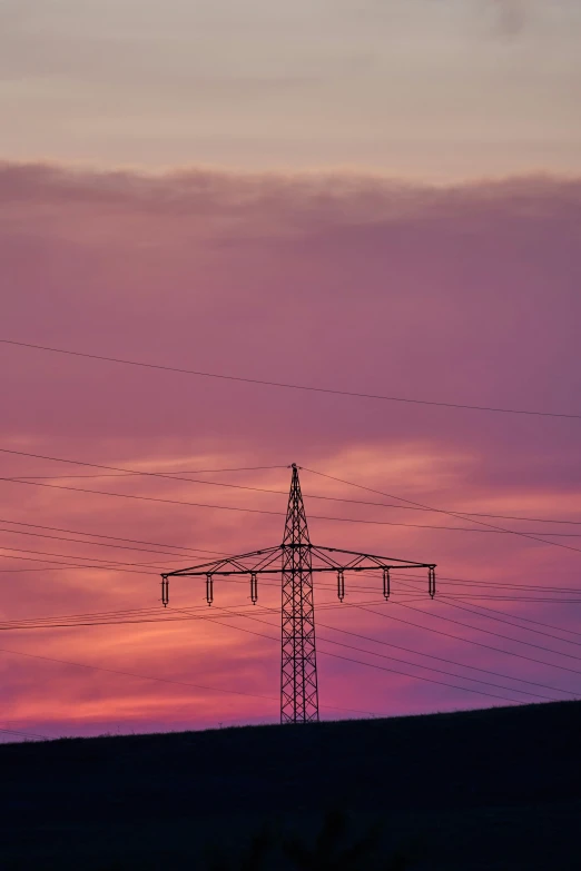 the power lines are running quickly in the dusk sky