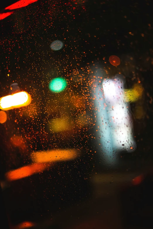 rain on the window with lights from traffic lights