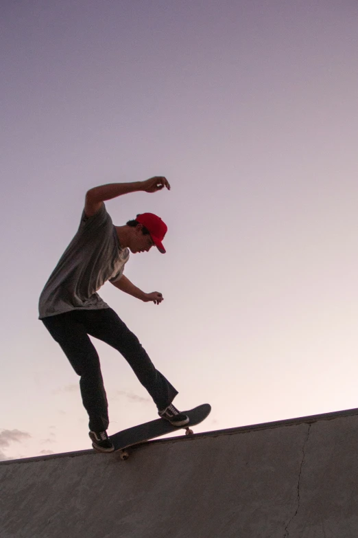 man skateboarding on a ramp and his hands are out as he makes a jump
