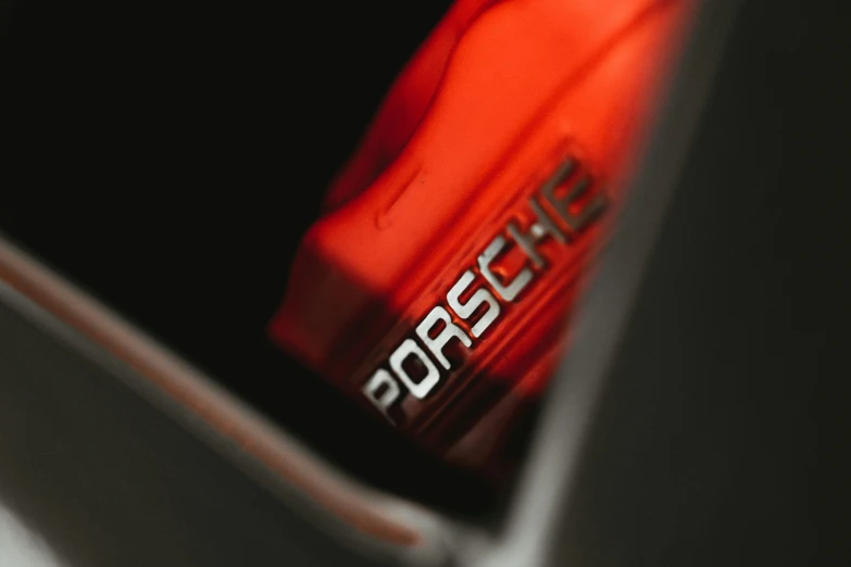 a red sports jersey with the word porsche printed on it