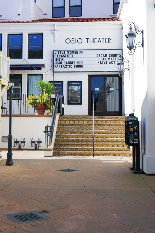 a building with stairs leading up to a parking meter