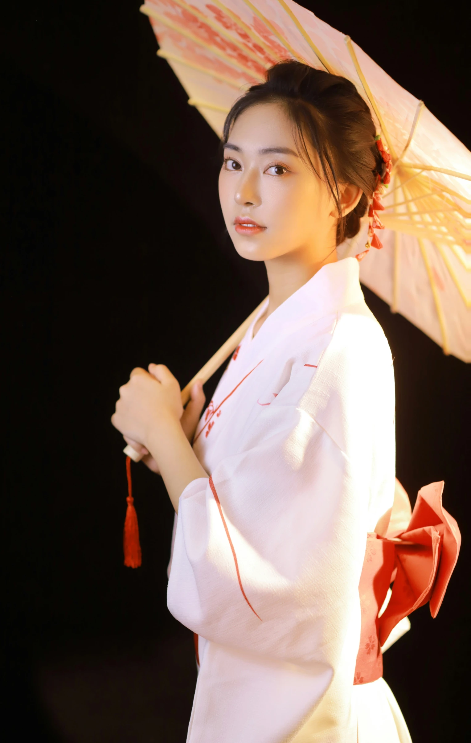 a beautiful woman in a white dress holding a umbrella