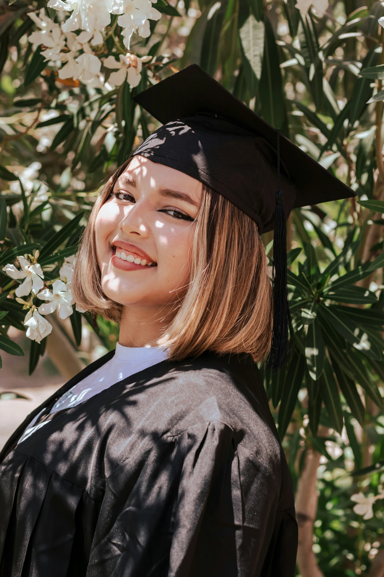 a  with a black graduation gown and cap