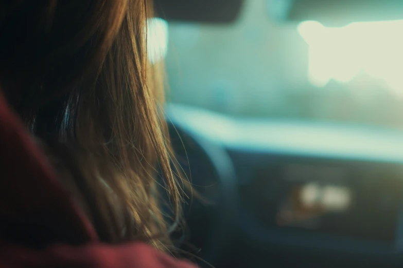 the side view of a woman's head from a passenger seat