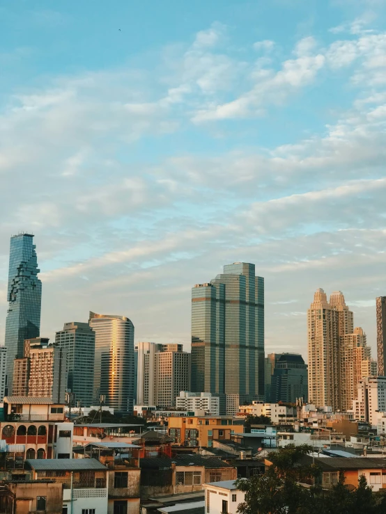 a city has tall buildings and clouds in the sky