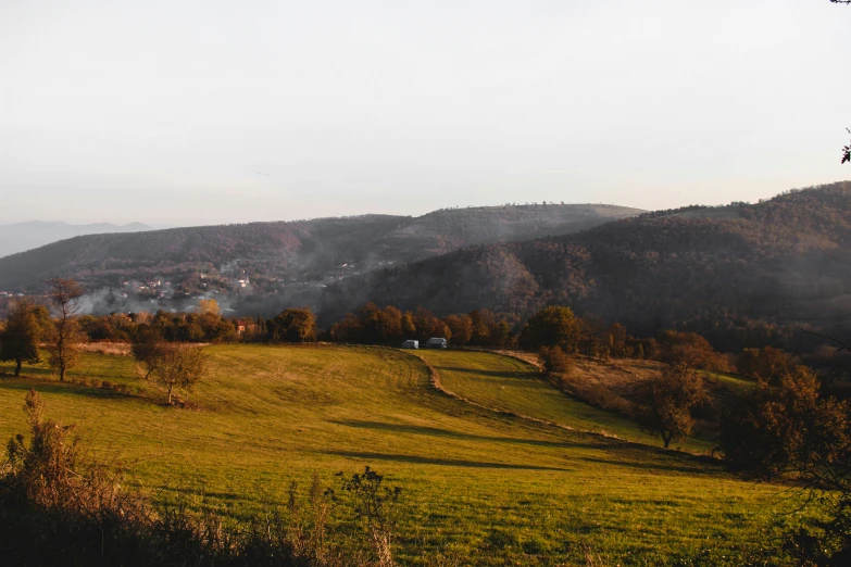 a green pasture in the middle of mountains