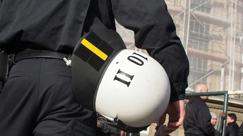 man in police uniform with helmet that reads, to go