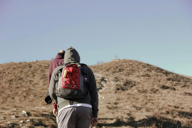 person standing on a rocky terrain with a backpack