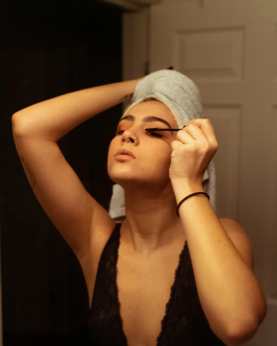 a woman putting on her hair while in the bathroom