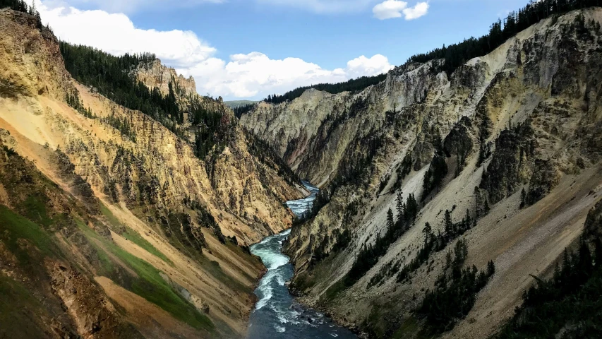 a river flowing between two cliff sides