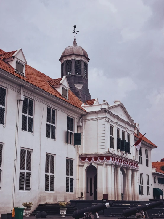 a large white building with many windows in front of it