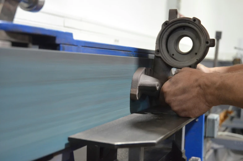 a man turning an object on top of a machine