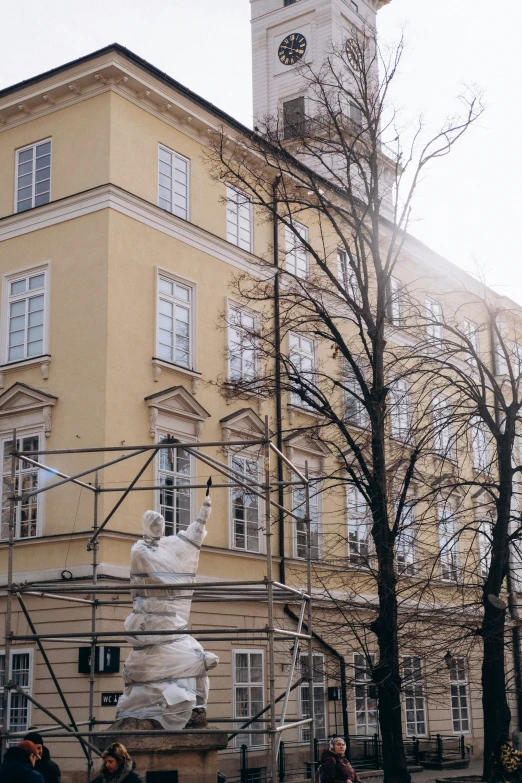 the sculpture is being displayed in front of the building