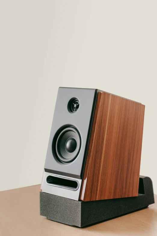 a wooden and metal speaker on a desk