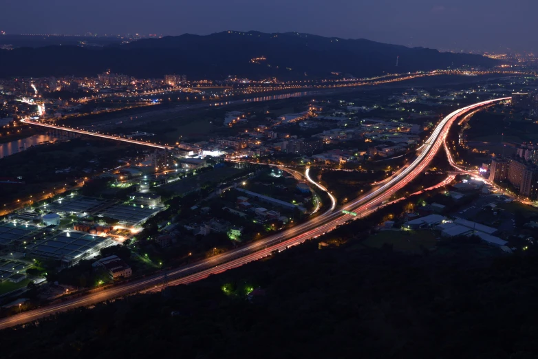 a city at night with cars and lights shining