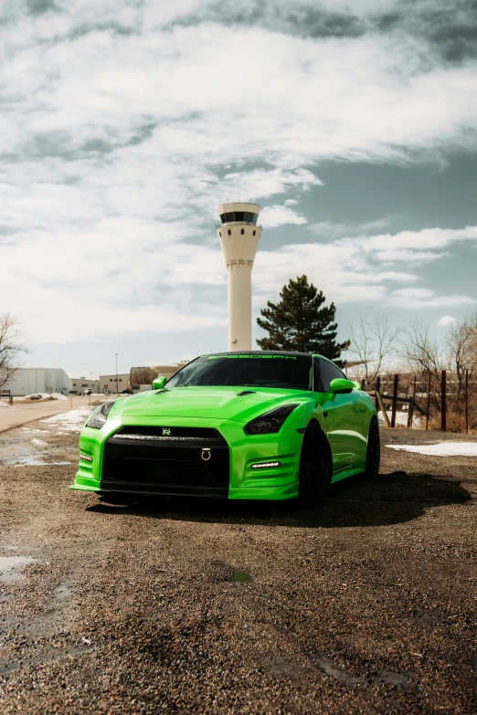 a green nissan sports car parked in a parking lot