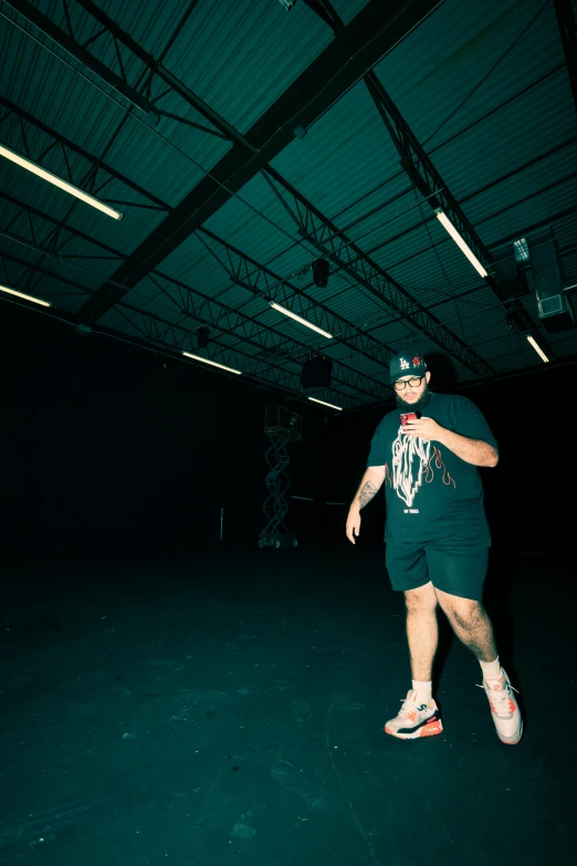 a man is standing in a dimly lit garage