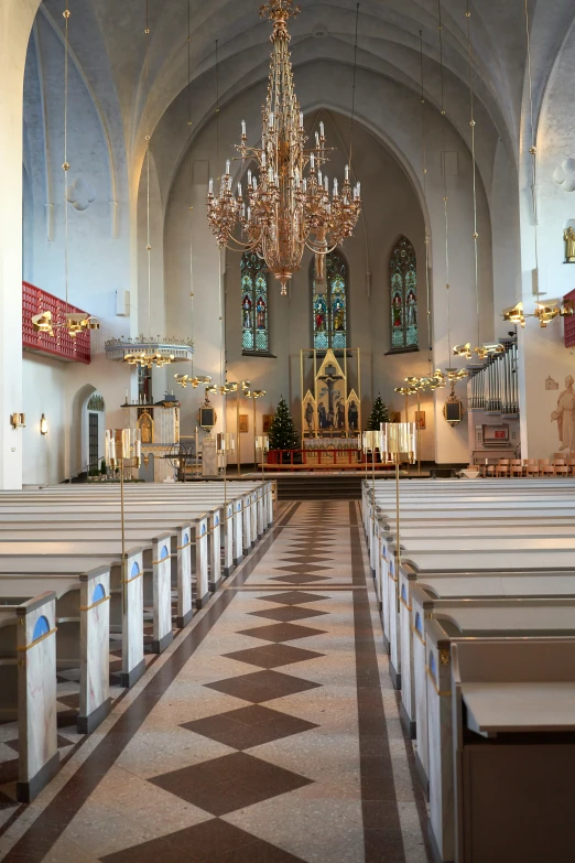 the inside of a large church with a chandelier