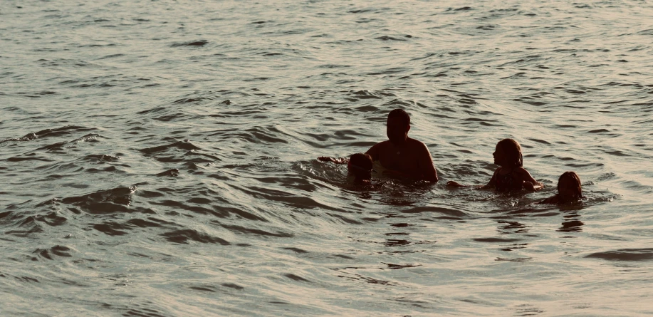 the mother and daughter are swimming in the ocean together