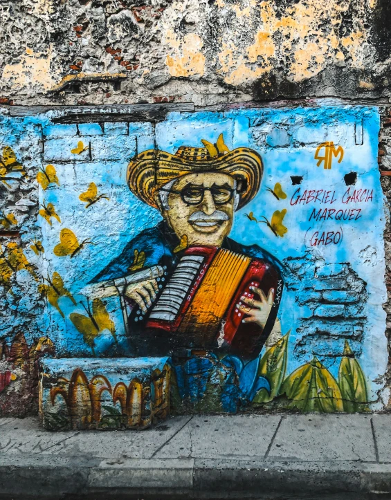 colorful painting on wall with man playing the accordion