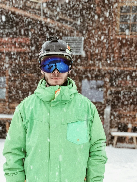 a person wearing a snowboard and goggles posing for a po