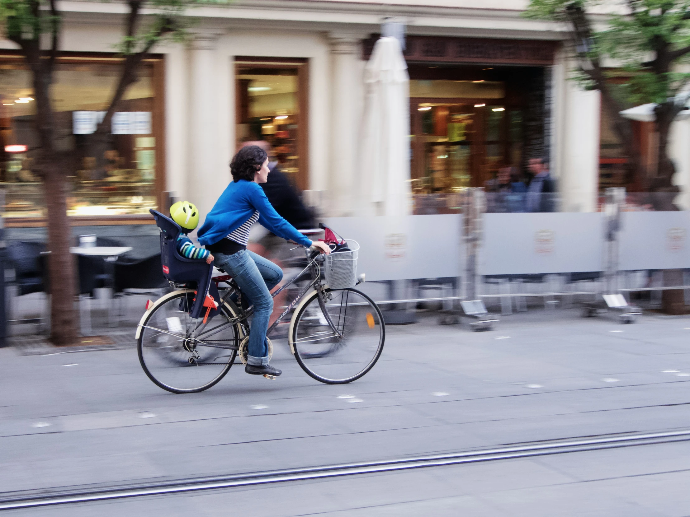 a couple of people riding bikes down a street