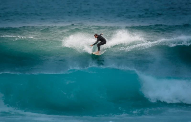 a surfer is riding the large wave in the ocean