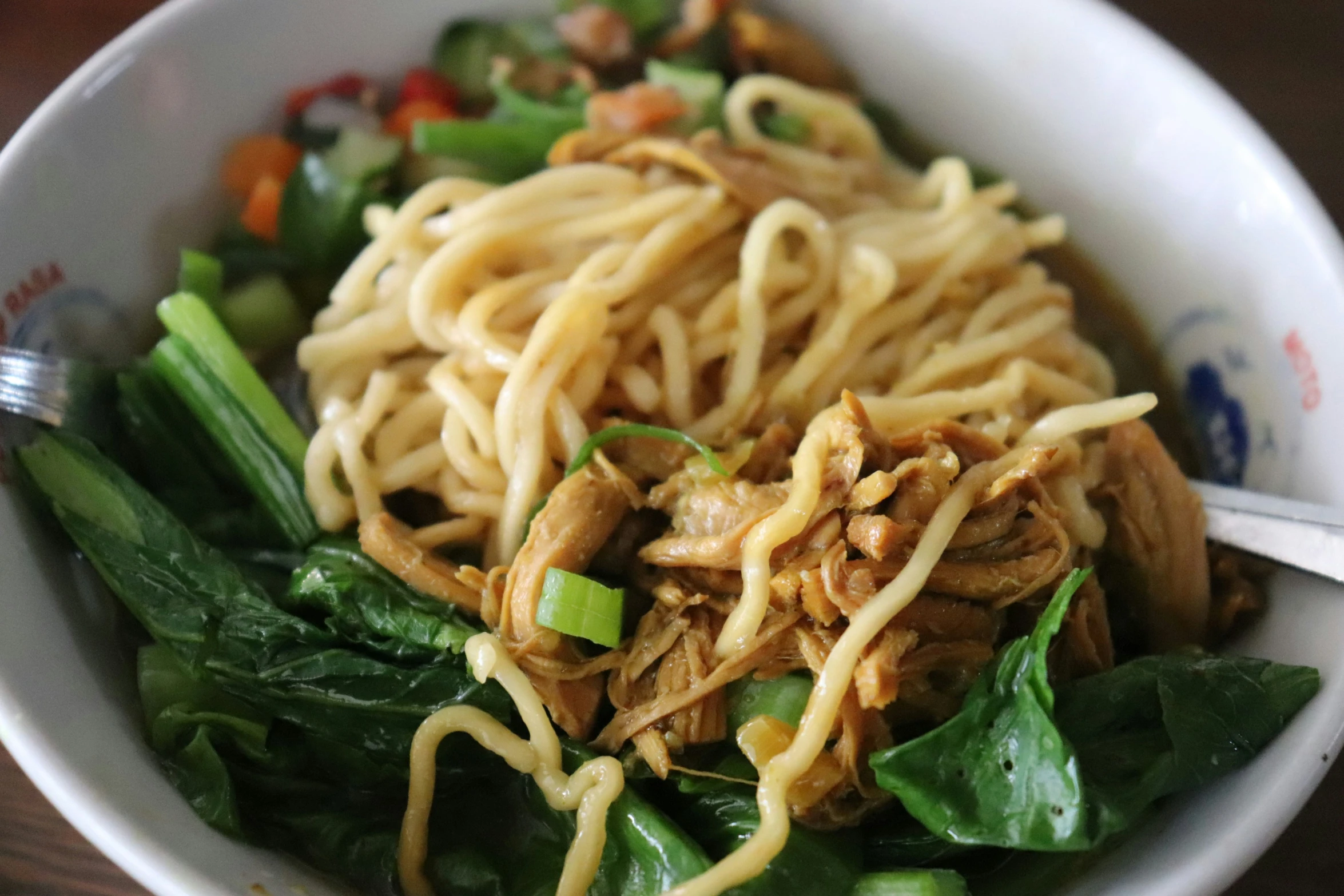 there is noodles and vegetables in the bowl