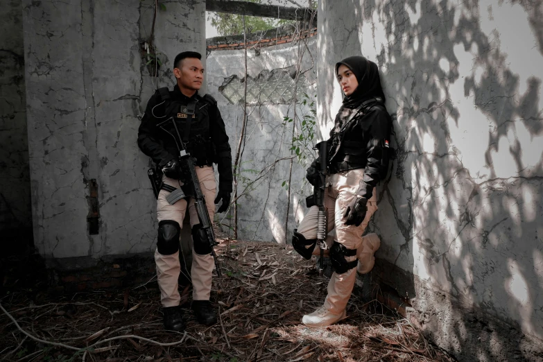 two men standing in the shadows by an abandoned wall