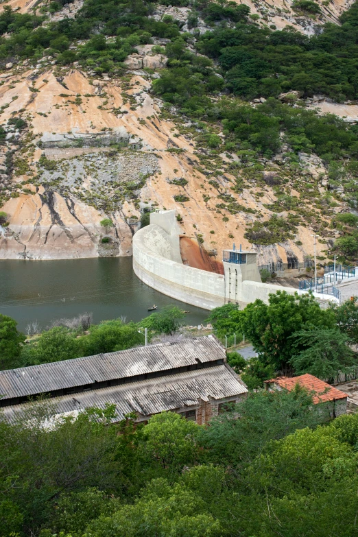 a hill that has a water wall and boats parked by it