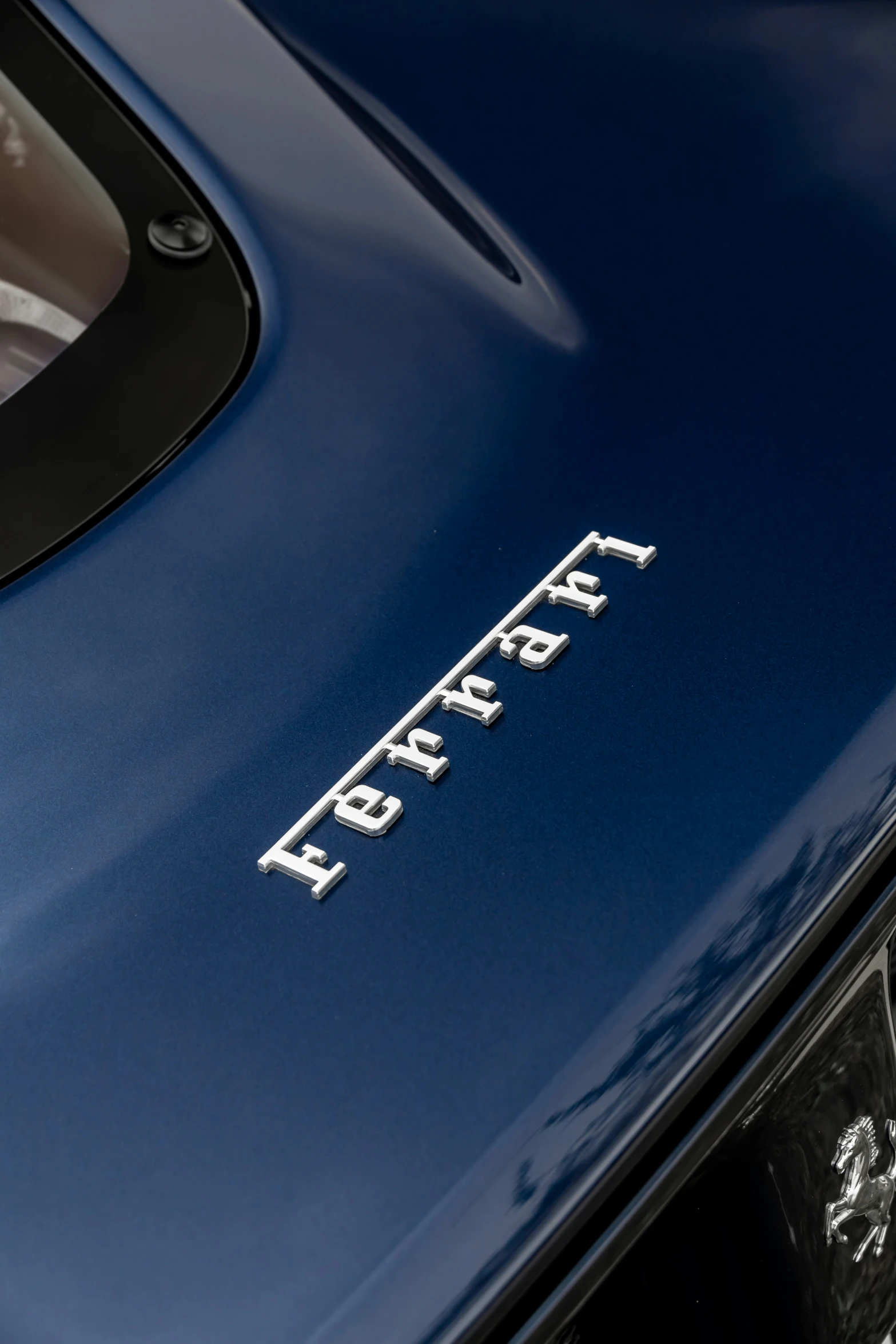 the front end of a blue sports car