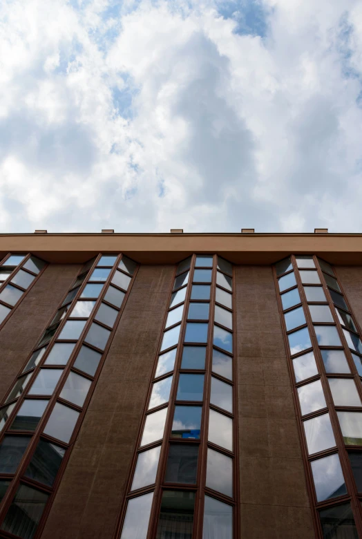 a brown building with windows that appear to be partially closed