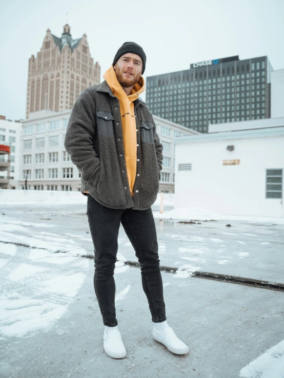 a person standing in the snow on top of a roof