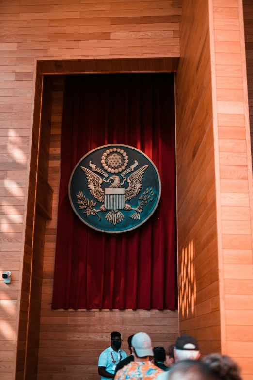 a sign on the side of a building above two people talking