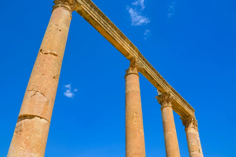 two large pillars in the sky with clouds above