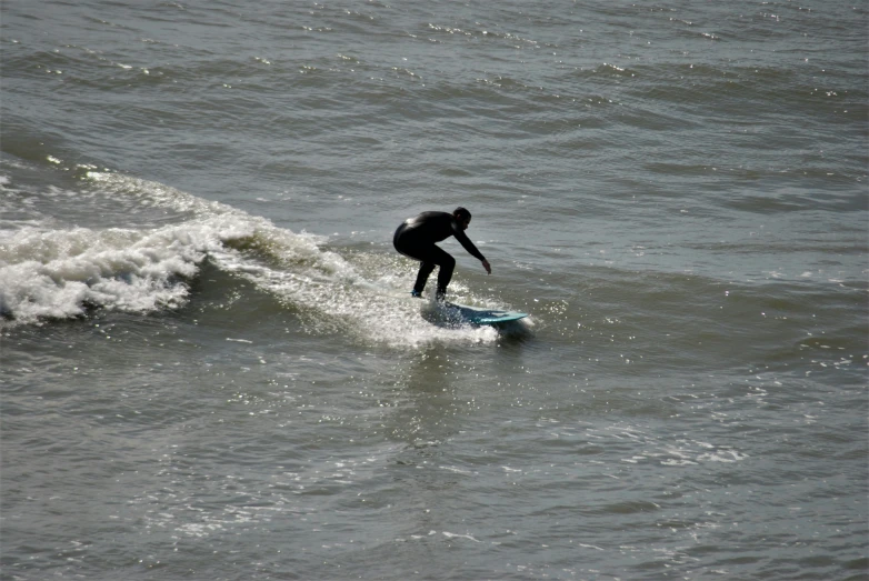 a surfer is surfing through the water at the beach