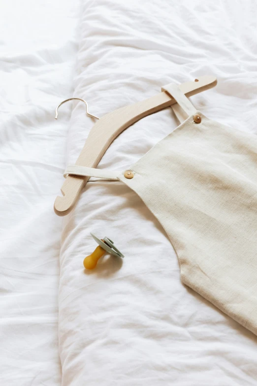 a white cloth and a piece of string sitting on a bed