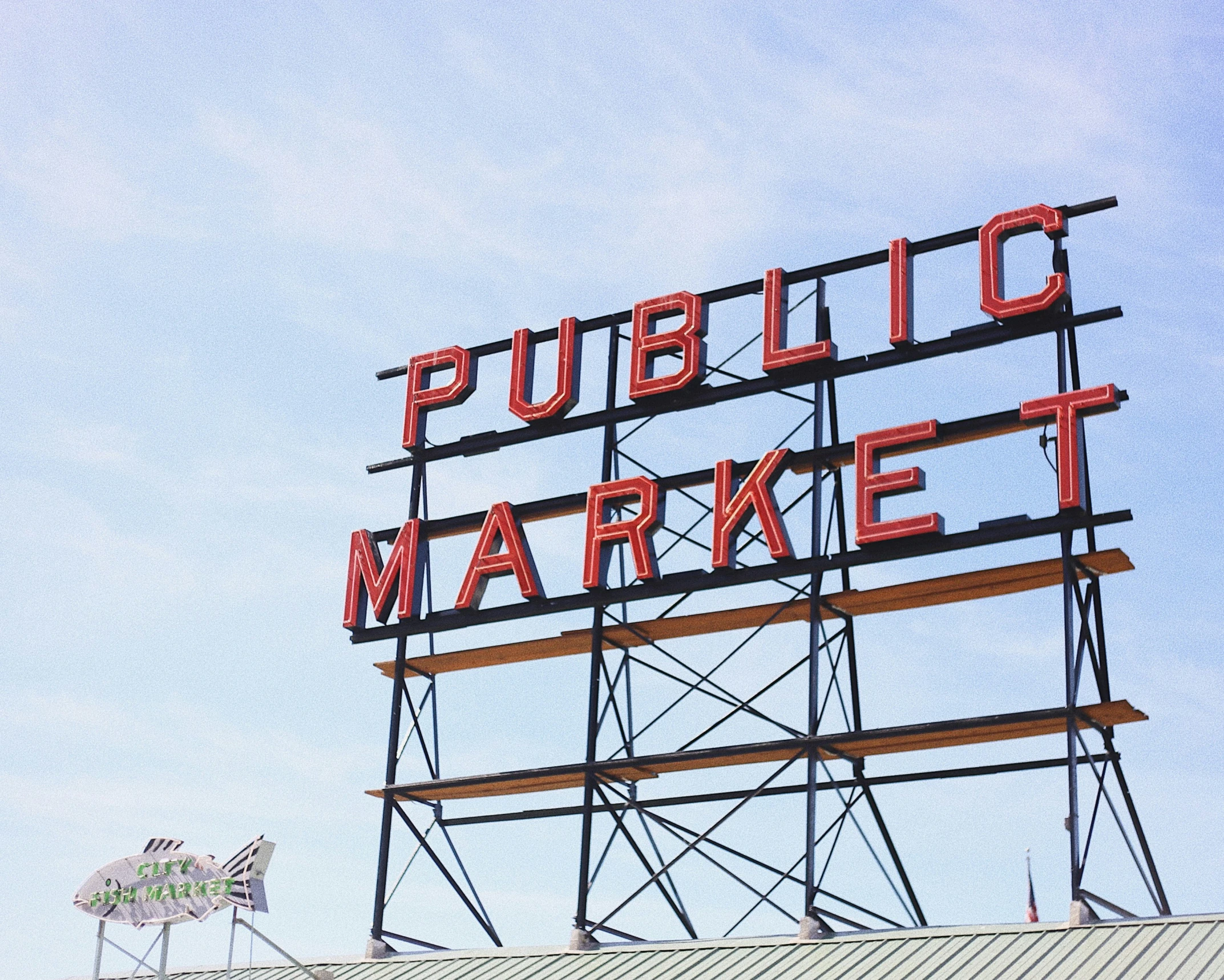 a giant red sign saying public market on top of a building