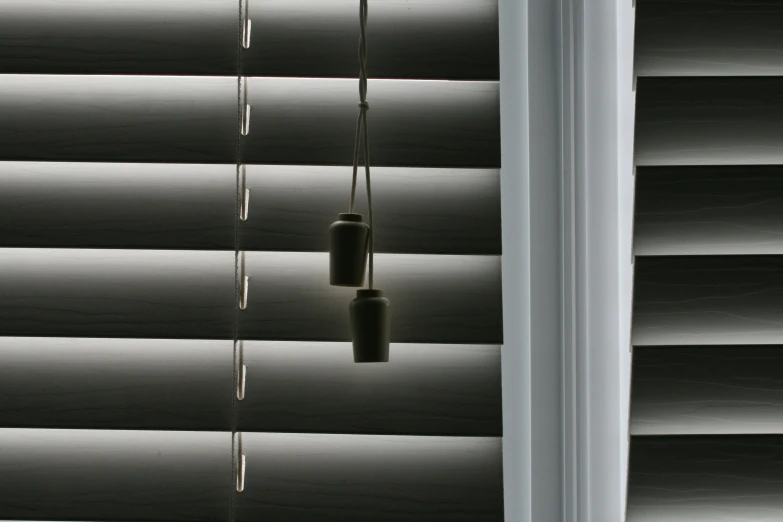 a window covered with blind shades with lights